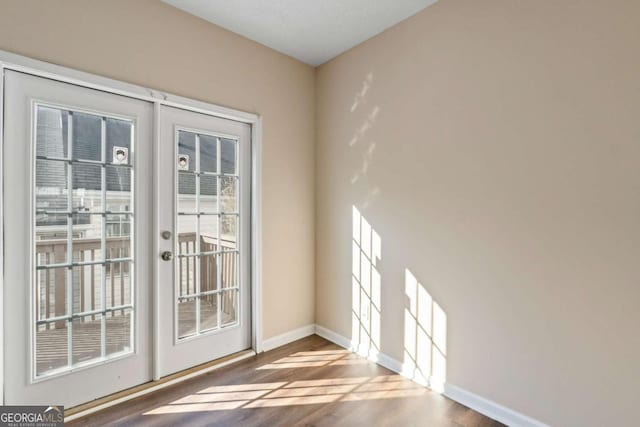 entryway featuring hardwood / wood-style floors and french doors