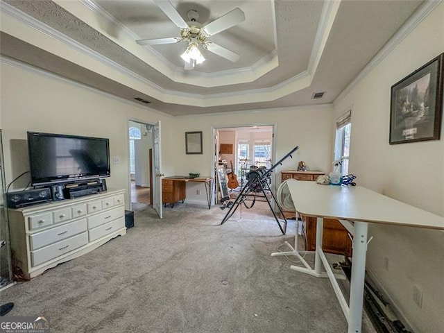 interior space featuring ceiling fan, ornamental molding, and a tray ceiling