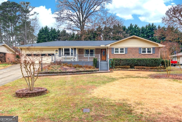 ranch-style house featuring a garage, covered porch, and a front lawn