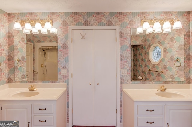 bathroom with a shower, vanity, and a textured ceiling