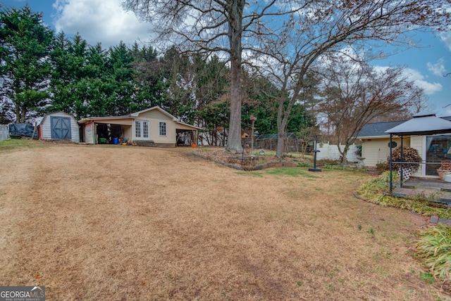 view of yard with a carport and a shed