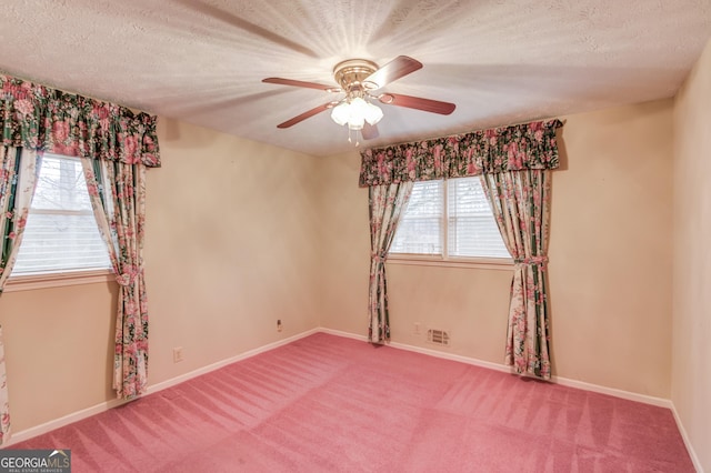 unfurnished room featuring ceiling fan, carpet flooring, and a textured ceiling