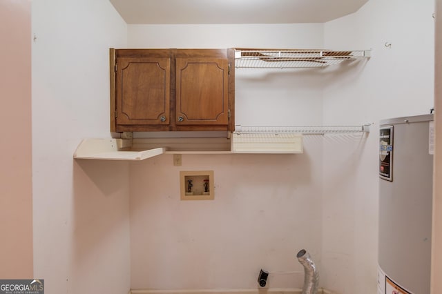 washroom with cabinets, hookup for an electric dryer, hookup for a washing machine, and gas water heater