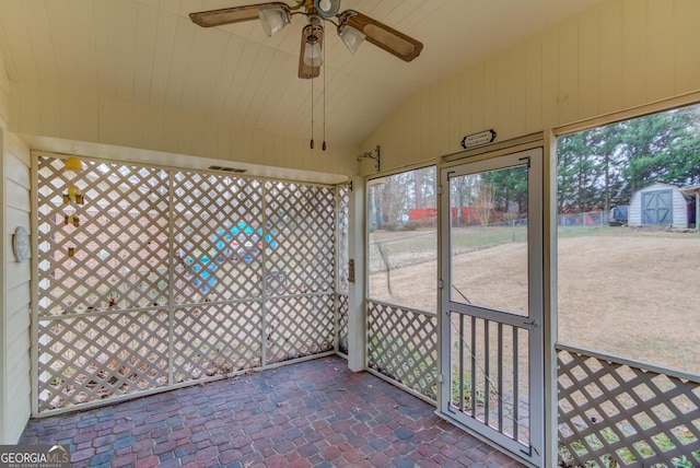 unfurnished sunroom with lofted ceiling and ceiling fan