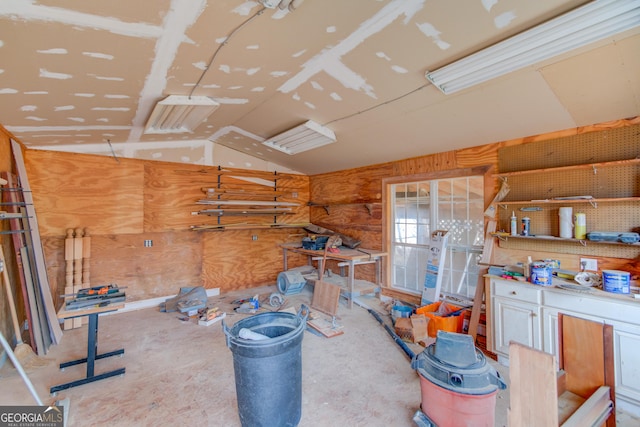 interior space featuring lofted ceiling and a workshop area