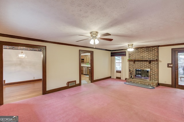 unfurnished living room featuring ornamental molding, a brick fireplace, light colored carpet, and a textured ceiling