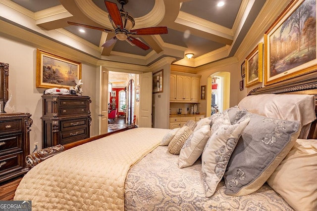 bedroom with coffered ceiling, hardwood / wood-style floors, and ornamental molding