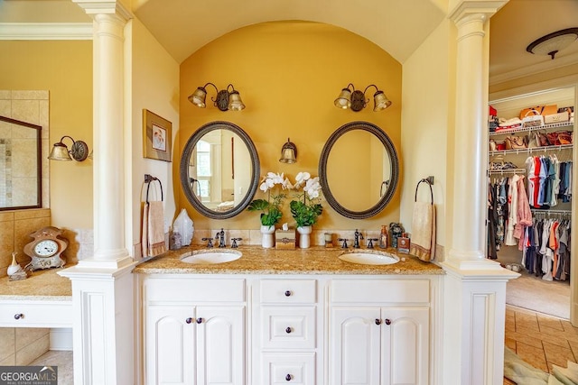 bathroom with vanity, walk in shower, and ornate columns