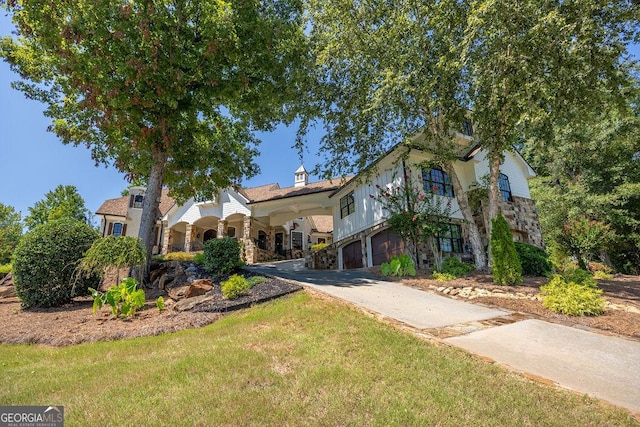 view of front of property featuring a garage and a front lawn