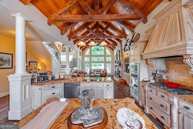 kitchen featuring stainless steel appliances, decorative columns, light stone counters, dark hardwood / wood-style flooring, and decorative backsplash