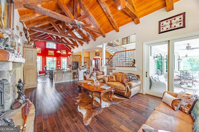 living room with a fireplace, wooden ceiling, ceiling fan, and plenty of natural light