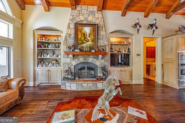 living room featuring dark hardwood / wood-style floors, a fireplace, built in features, and a high ceiling