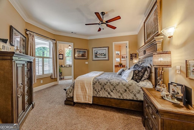 carpeted bedroom with ceiling fan, ornamental molding, and ensuite bathroom