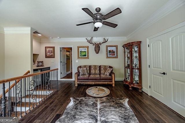 living room featuring ceiling fan, ornamental molding, and dark hardwood / wood-style flooring