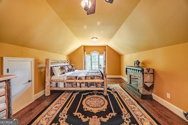 bedroom featuring dark hardwood / wood-style flooring and vaulted ceiling