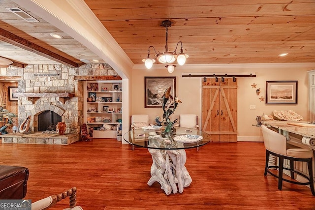 dining room with crown molding, a barn door, hardwood / wood-style floors, and wooden ceiling