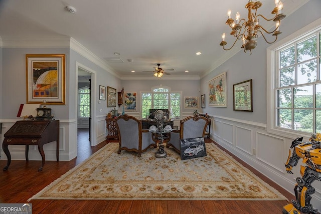 dining area featuring dark wood-type flooring, ornamental molding, and ceiling fan