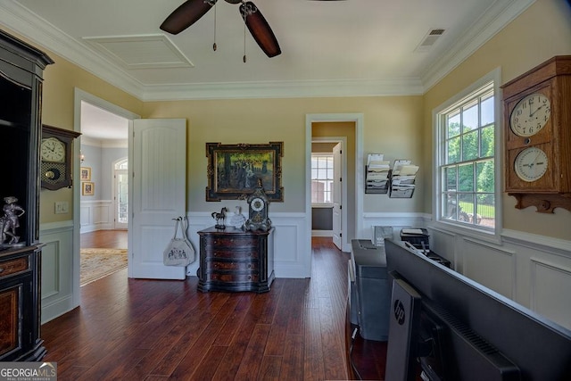 interior space featuring dark hardwood / wood-style flooring, ornamental molding, and ceiling fan