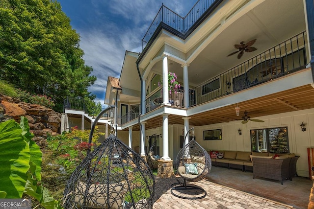 exterior space featuring a balcony, outdoor lounge area, ceiling fan, and a patio area