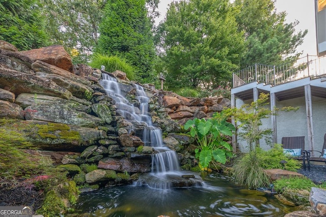 view of home's community featuring a garden pond