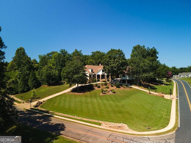 view of property's community with a lawn