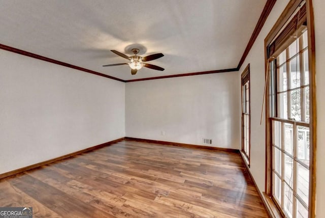 spare room featuring crown molding, hardwood / wood-style flooring, and ceiling fan