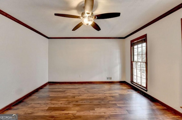 spare room with ornamental molding, ceiling fan, and dark hardwood / wood-style flooring