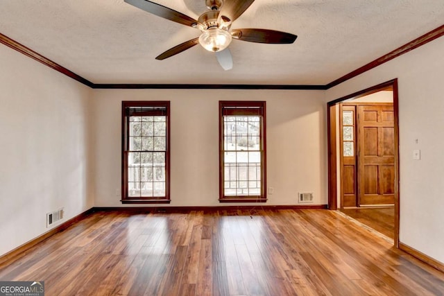 unfurnished room featuring ceiling fan, crown molding, wood-type flooring, and a textured ceiling