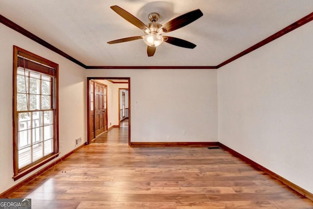 empty room with crown molding, ceiling fan, and light hardwood / wood-style floors