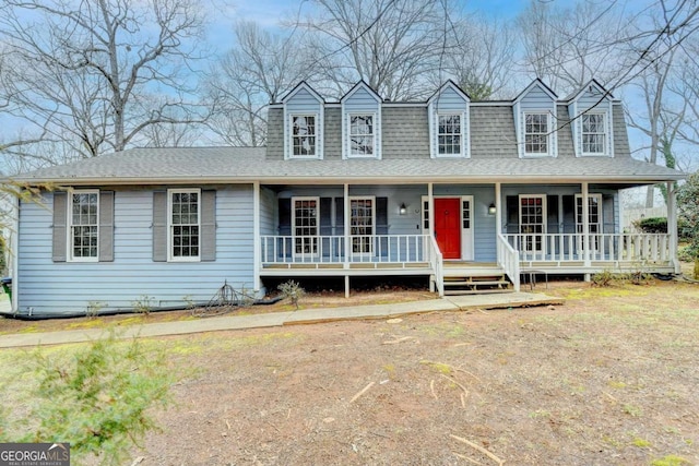 view of front of house with covered porch and a front lawn