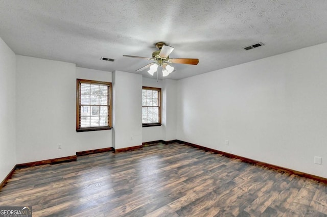 unfurnished room with ceiling fan, dark hardwood / wood-style flooring, and a textured ceiling