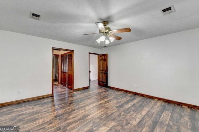 unfurnished room featuring dark hardwood / wood-style floors and ceiling fan