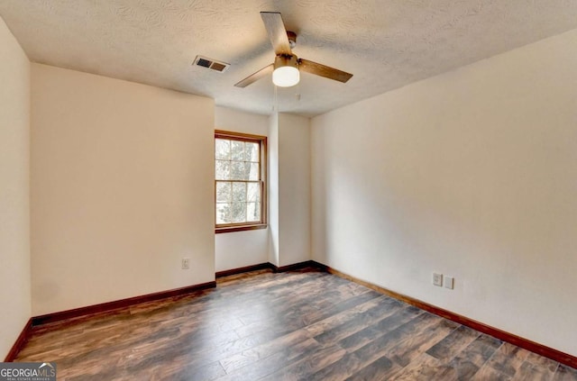 spare room with a textured ceiling, dark hardwood / wood-style floors, and ceiling fan