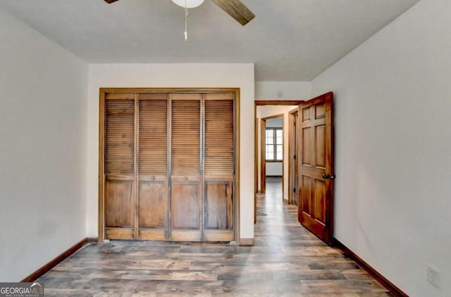 bedroom with dark hardwood / wood-style floors, ceiling fan, and a closet