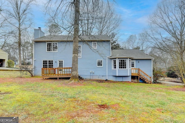 back of property with a wooden deck and a lawn