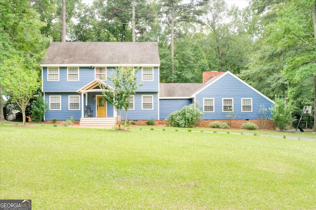 colonial-style house featuring a porch and a front lawn