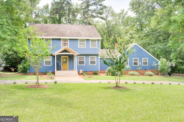 colonial-style house with a front lawn