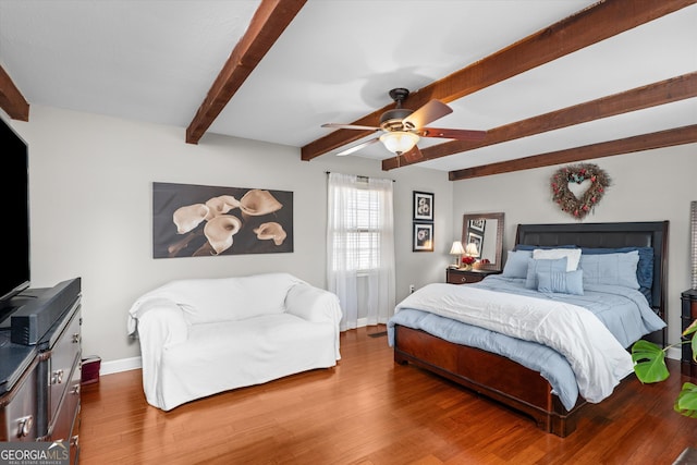 bedroom with hardwood / wood-style floors, beam ceiling, and ceiling fan