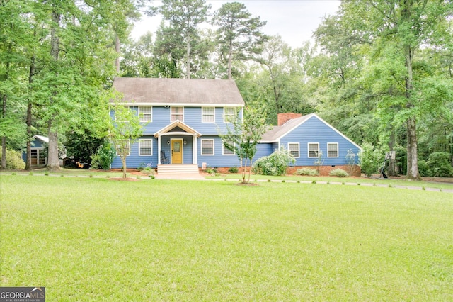 colonial inspired home with a front lawn