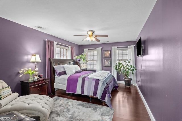 bedroom with dark hardwood / wood-style floors and ceiling fan