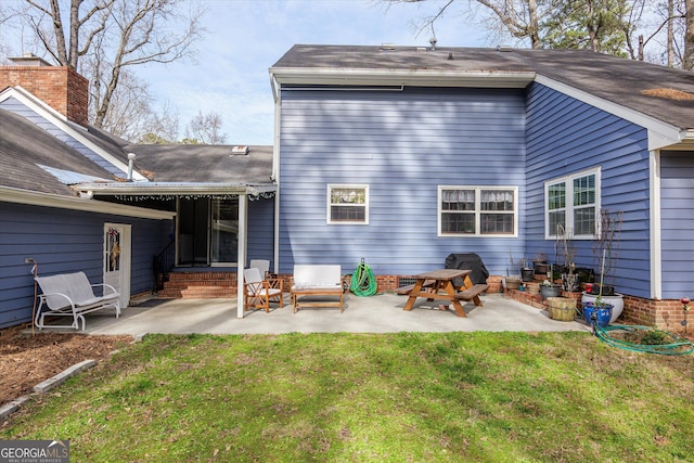 back of house with a yard and a patio area