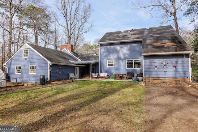 rear view of house featuring a yard and a patio area