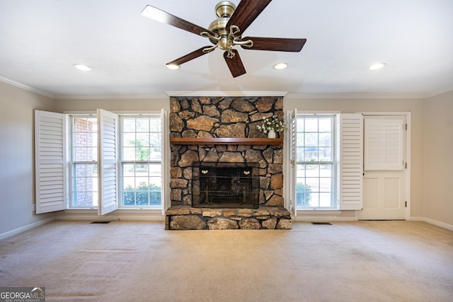 unfurnished living room with ornamental molding, light carpet, and a fireplace