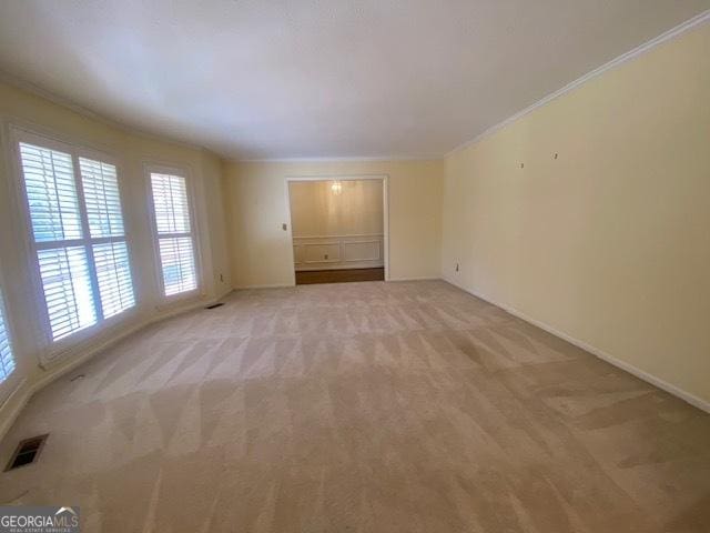 carpeted empty room with ornamental molding