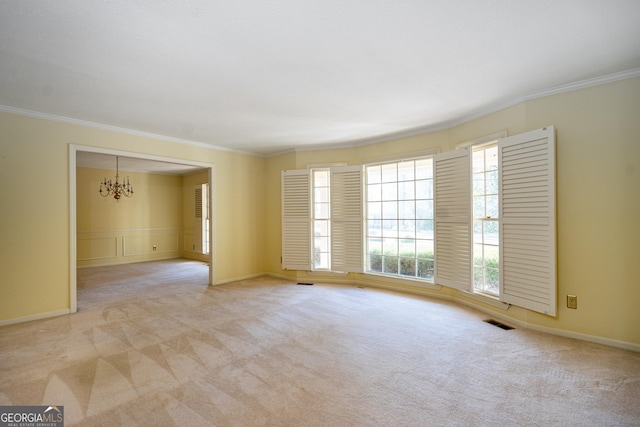 carpeted empty room featuring a notable chandelier and crown molding