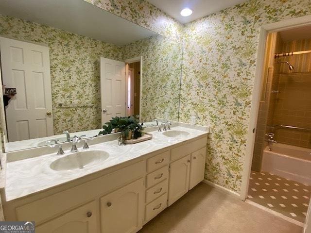 bathroom with vanity and tiled shower / bath combo