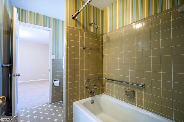 bathroom featuring tile walls and tiled shower / bath