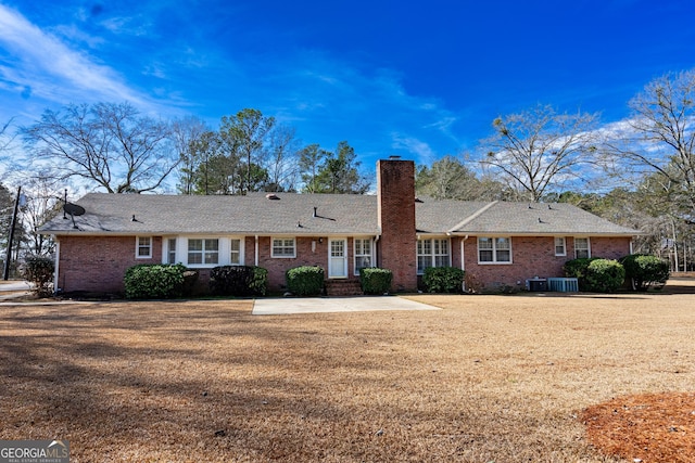 back of house featuring a patio, central AC unit, and a lawn