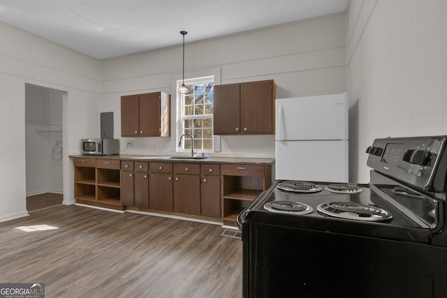 kitchen featuring pendant lighting, sink, dark wood-type flooring, electric range, and white refrigerator