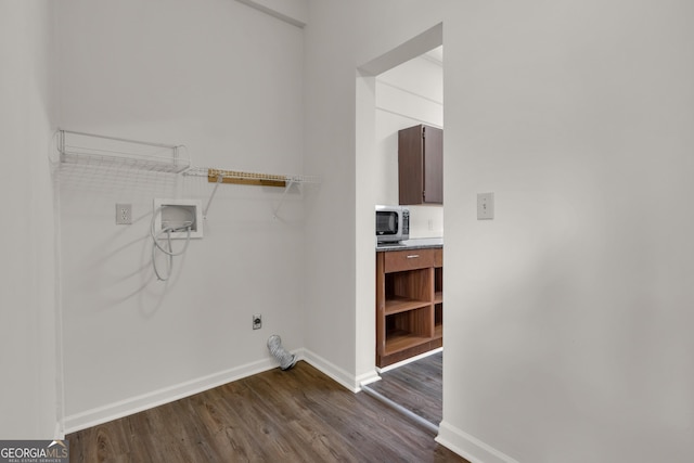 clothes washing area featuring electric dryer hookup, washer hookup, and dark hardwood / wood-style flooring